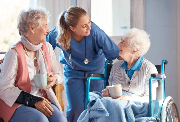 Registered nurse caring for an elderly resident in a long-term care facility